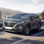 Side view of the Hyundai Santa Fe SUV parked outdoors, showcasing its sleek design. Modern headlights and bold grille highlight the Santa Fe’s dynamic exterior.