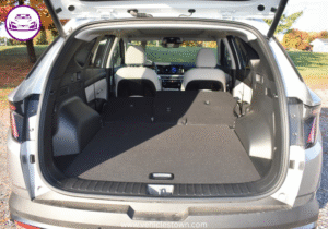 "Side view of the Hyundai Tucson Hybrid SUV in motion, showcasing its sleek design and eco-friendly features"