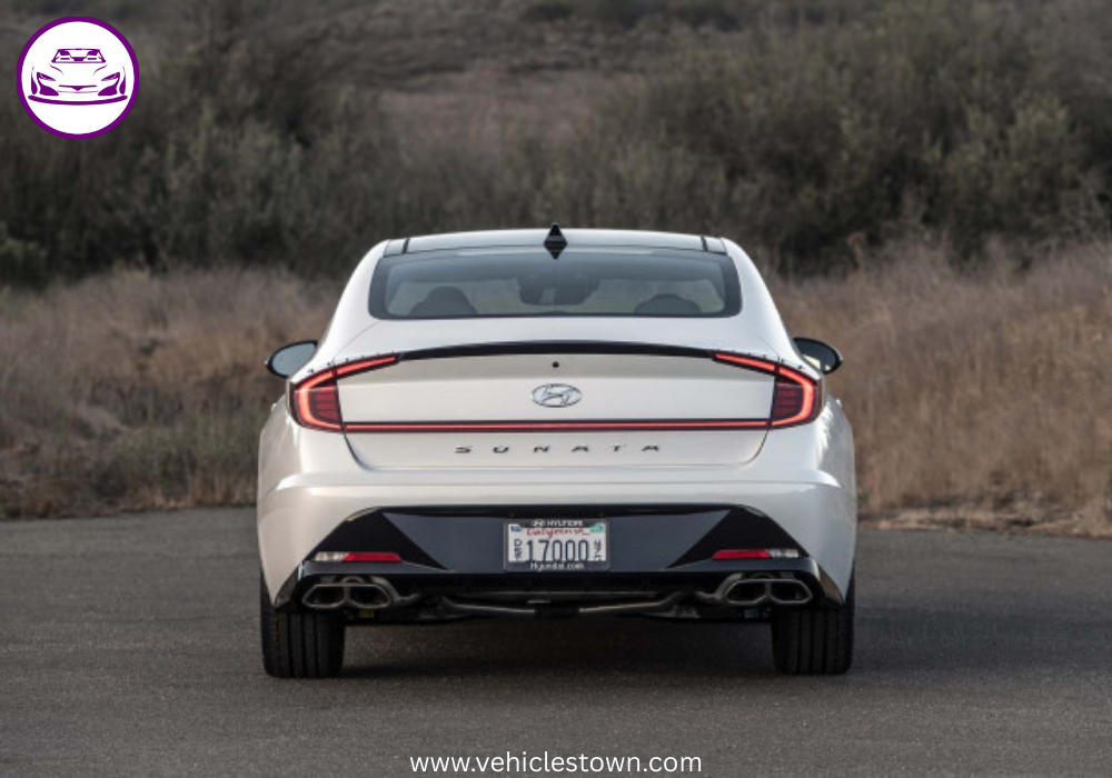 Side view of a sleek silver Hyundai Sonata parked under daylight. Modern midsize sedan showcasing bold design and aerodynamic curves.