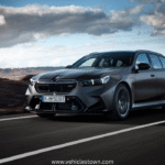 2025 BMW M5 Touring in motion, showcasing its sleek design, hybrid performance, and M xDrive system.