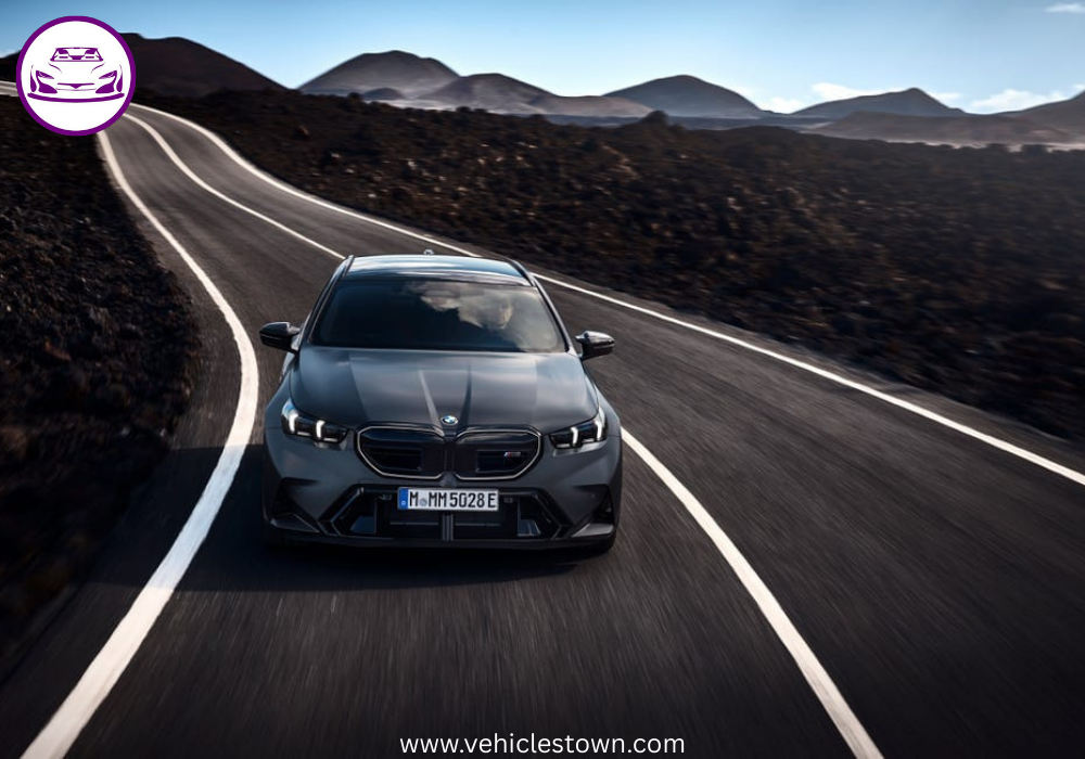 2025 BMW M5 Touring in motion, showcasing its sleek design, hybrid performance, and M xDrive system.