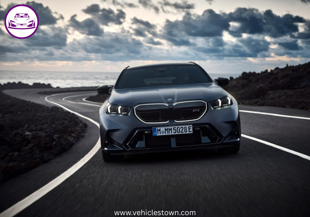 2025 BMW M5 Touring in motion, showcasing its sleek design, hybrid performance, and M xDrive system.