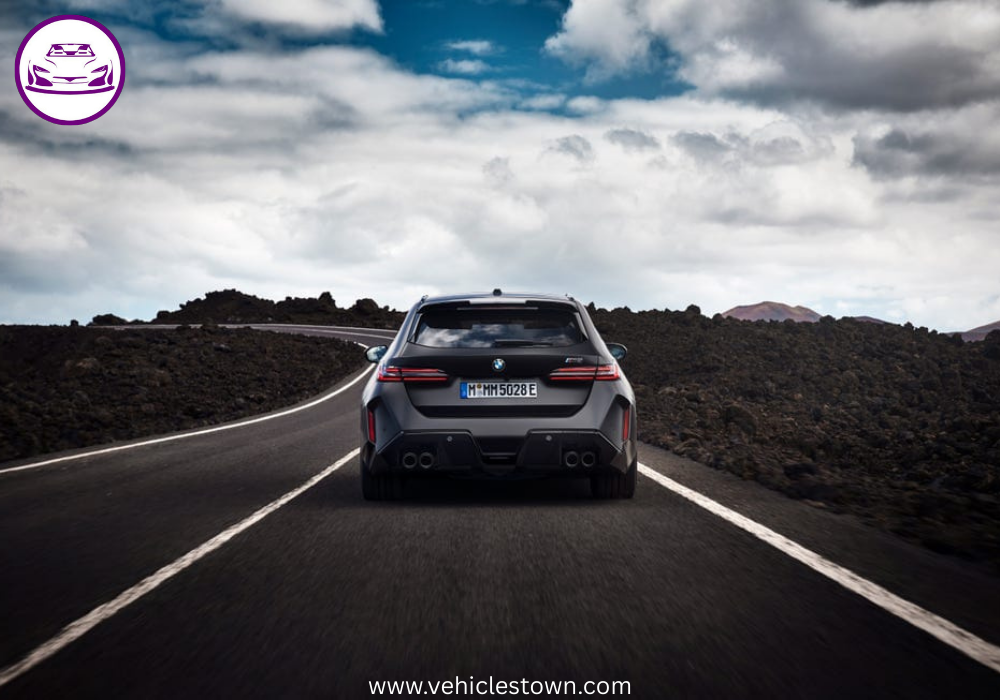 2025 BMW M5 Touring in motion, showcasing its sleek design, hybrid performance, and M xDrive system.