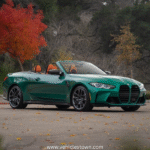 "BMW M4 Convertible xDrive in motion with sleek design and open-top driving, showcasing powerful performance and luxury."