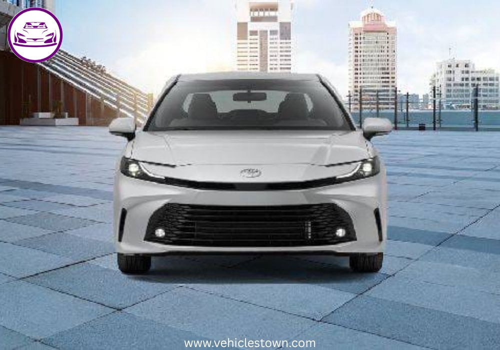 **Alt Text:**
Toyota Camry LE 2025 – elegant silver sedan with sleek LED headlights and stylish body lines, parked in a modern urban setting.