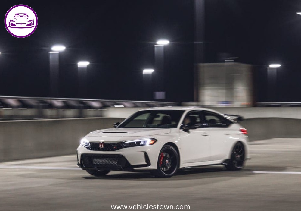Front view of the bold and sporty red Honda Civic Type R showcasing its aggressive grille and large rear wing.