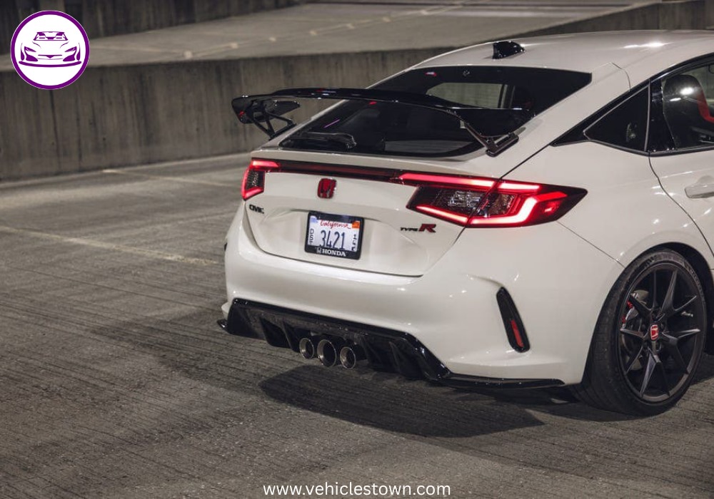 Front view of the bold and sporty red Honda Civic Type R showcasing its aggressive grille and large rear wing.