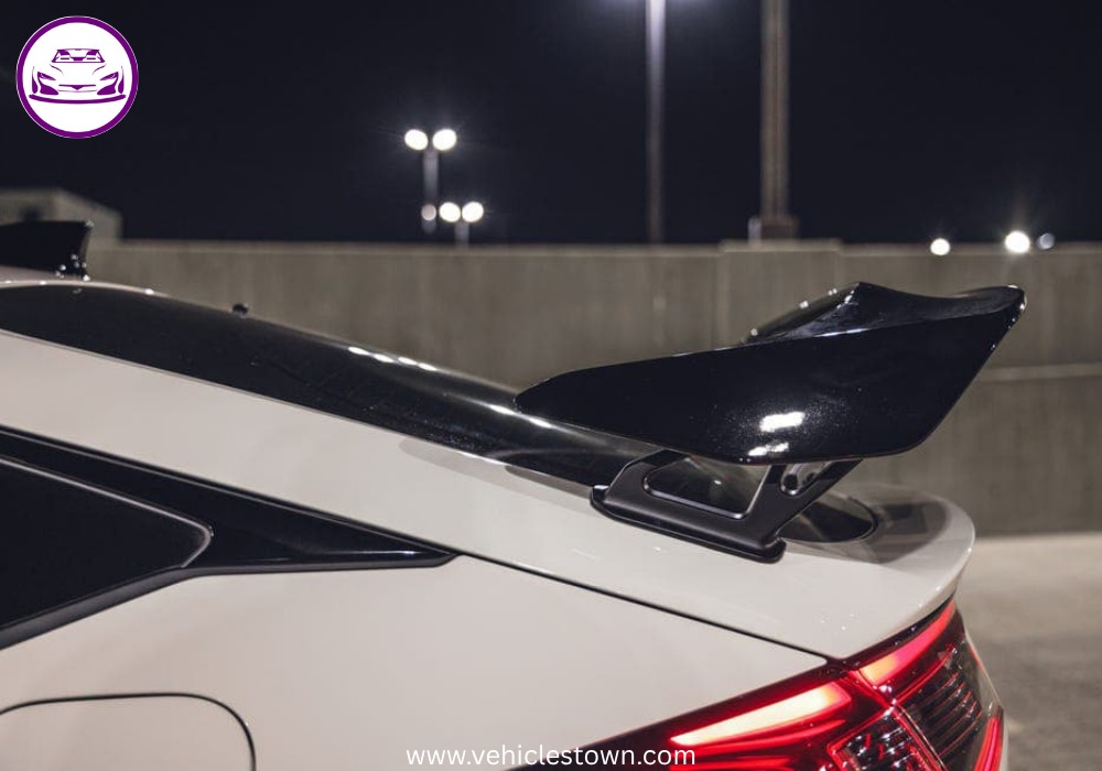Front view of the bold and sporty red Honda Civic Type R showcasing its aggressive grille and large rear wing.