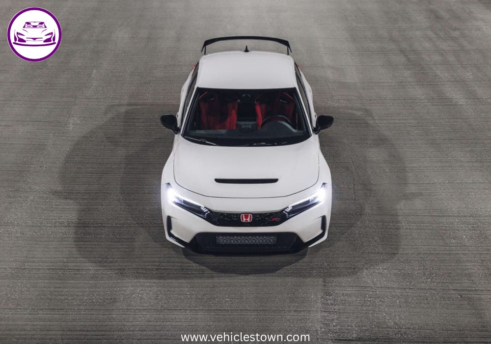 Front view of the bold and sporty red Honda Civic Type R showcasing its aggressive grille and large rear wing.