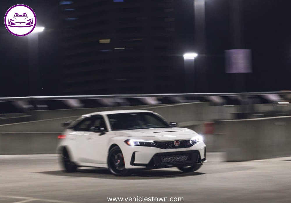 Front view of the bold and sporty red Honda Civic Type R showcasing its aggressive grille and large rear wing.