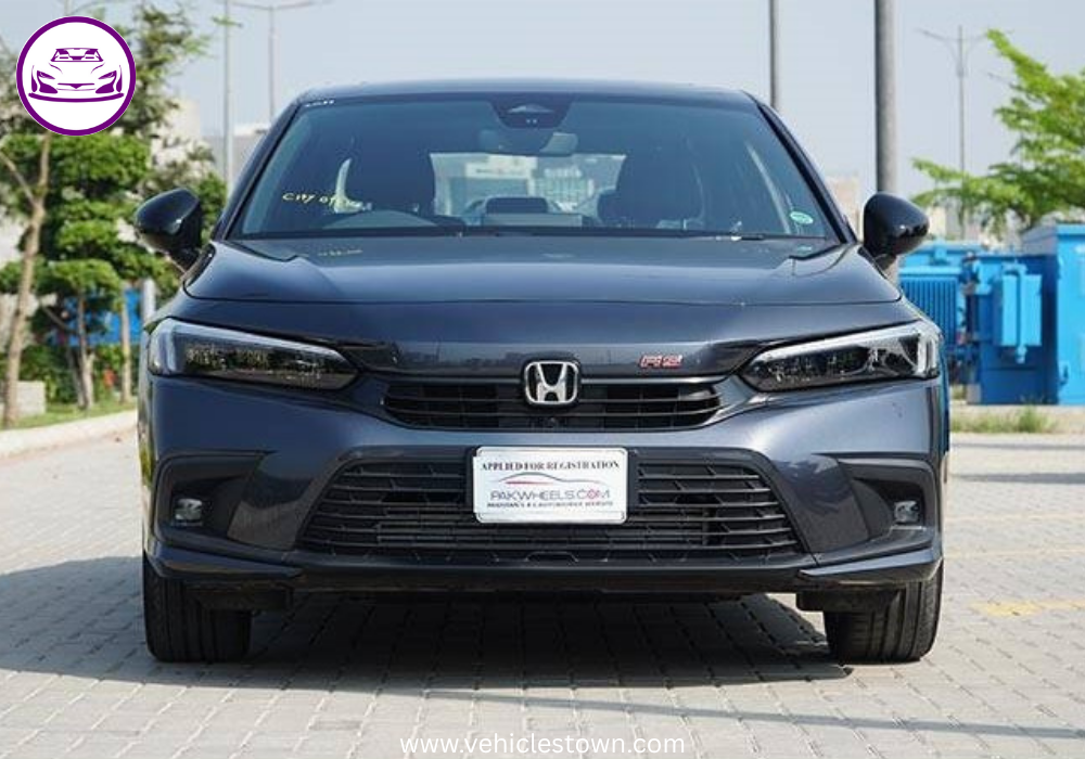 Honda Civic RS parked outdoors, showcasing sleek design and black alloy wheels.