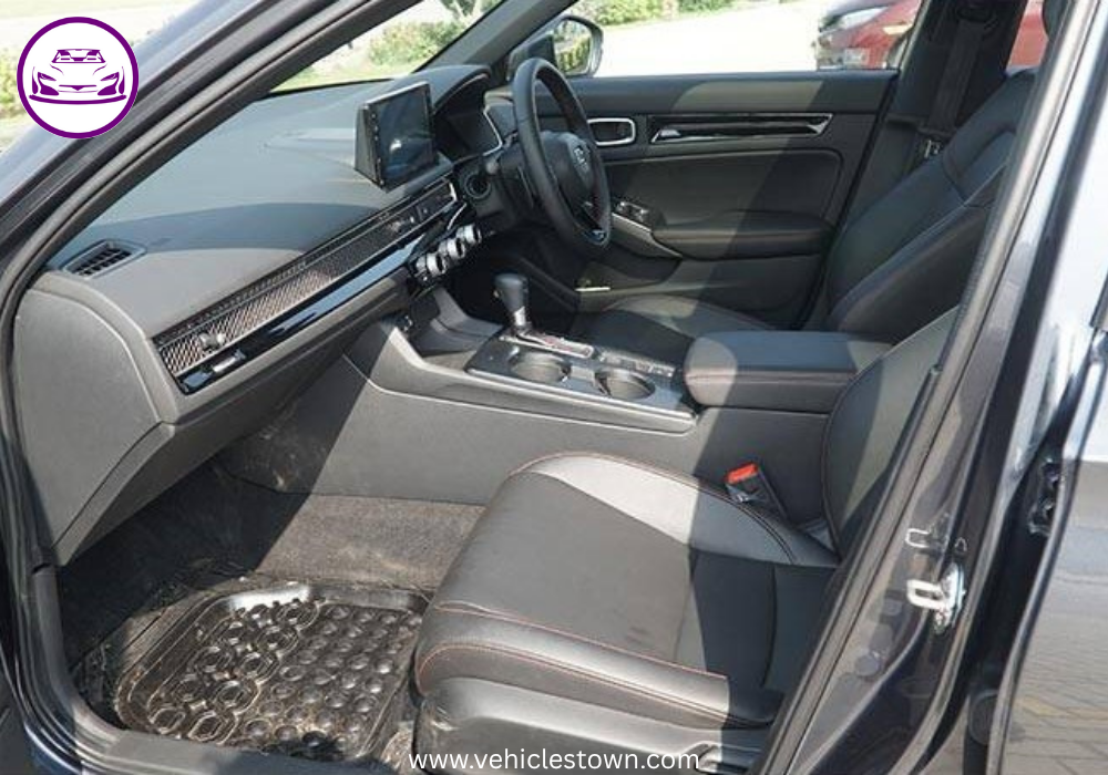 Honda Civic RS parked outdoors, showcasing sleek design and black alloy wheels.