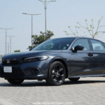 Honda Civic RS parked outdoors, showcasing sleek design and black alloy wheels.