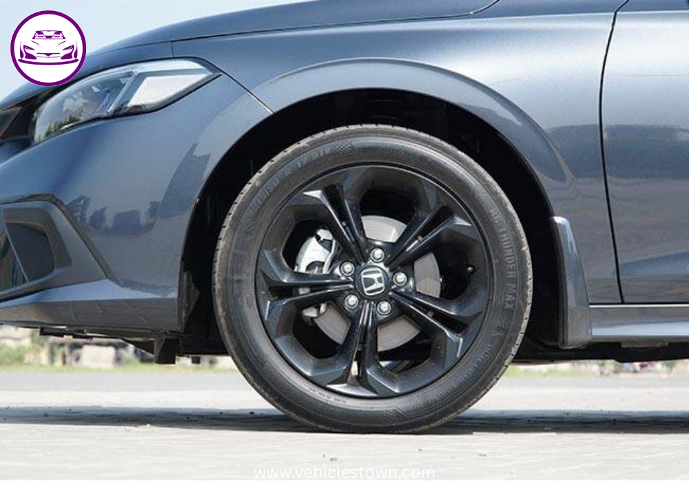 Honda Civic RS parked outdoors, showcasing sleek design and black alloy wheels.
