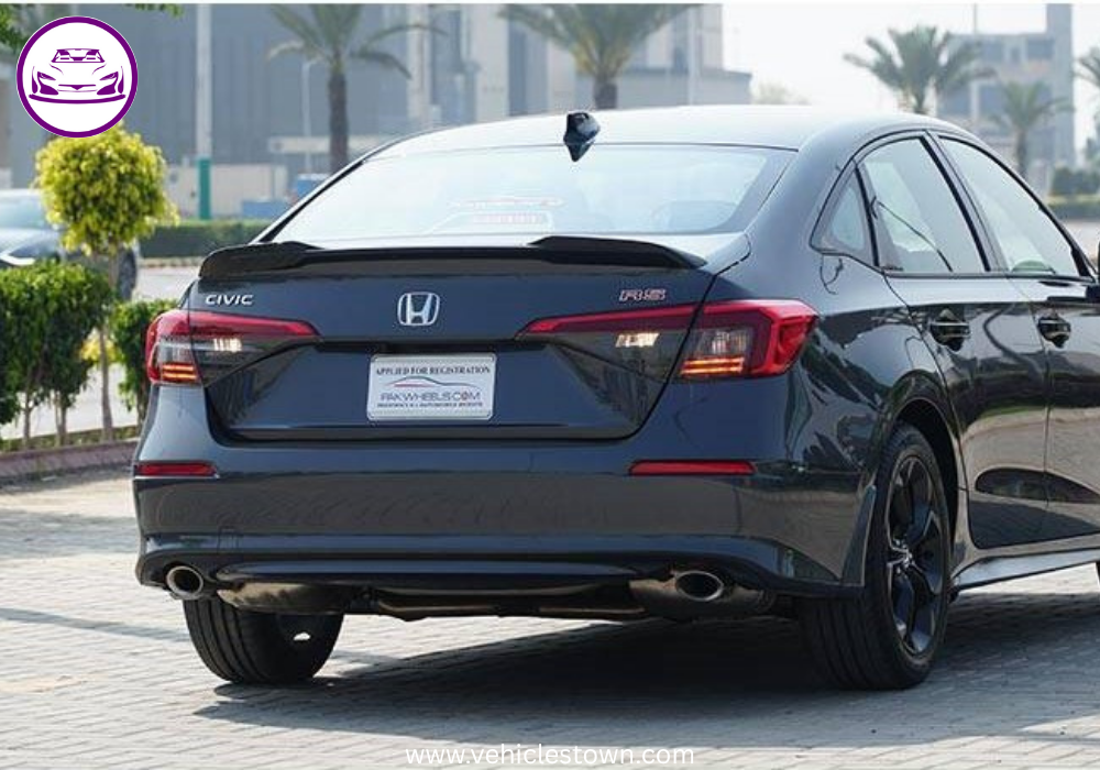 Honda Civic RS parked outdoors, showcasing sleek design and black alloy wheels.