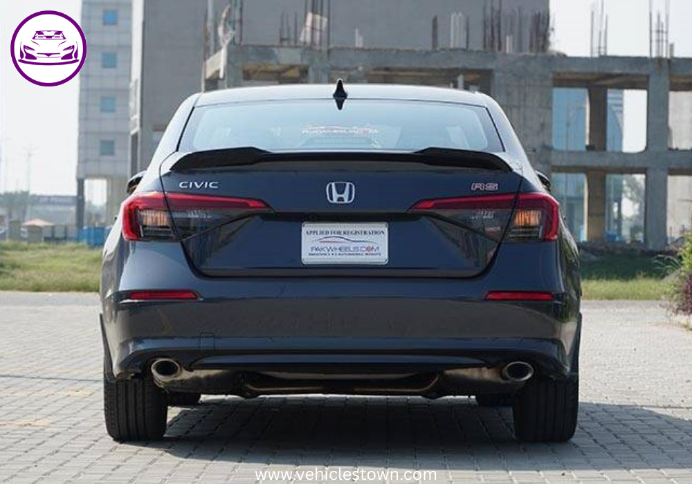 Honda Civic RS parked outdoors, showcasing sleek design and black alloy wheels.