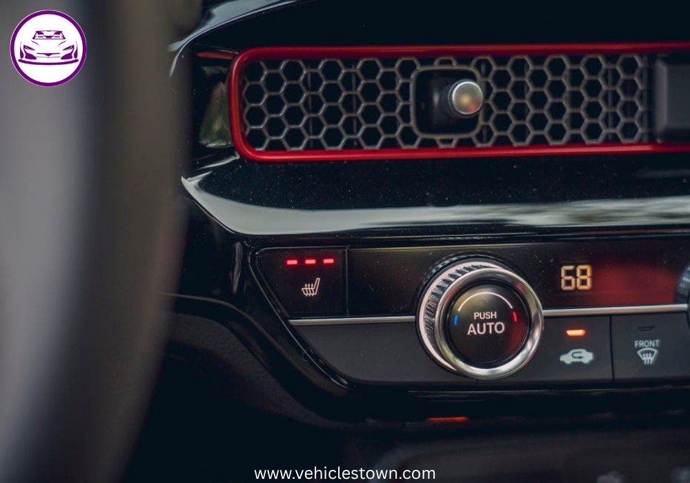 Honda Civic Si sporty red sedan parked, showcasing aggressive front grille and alloy wheels.