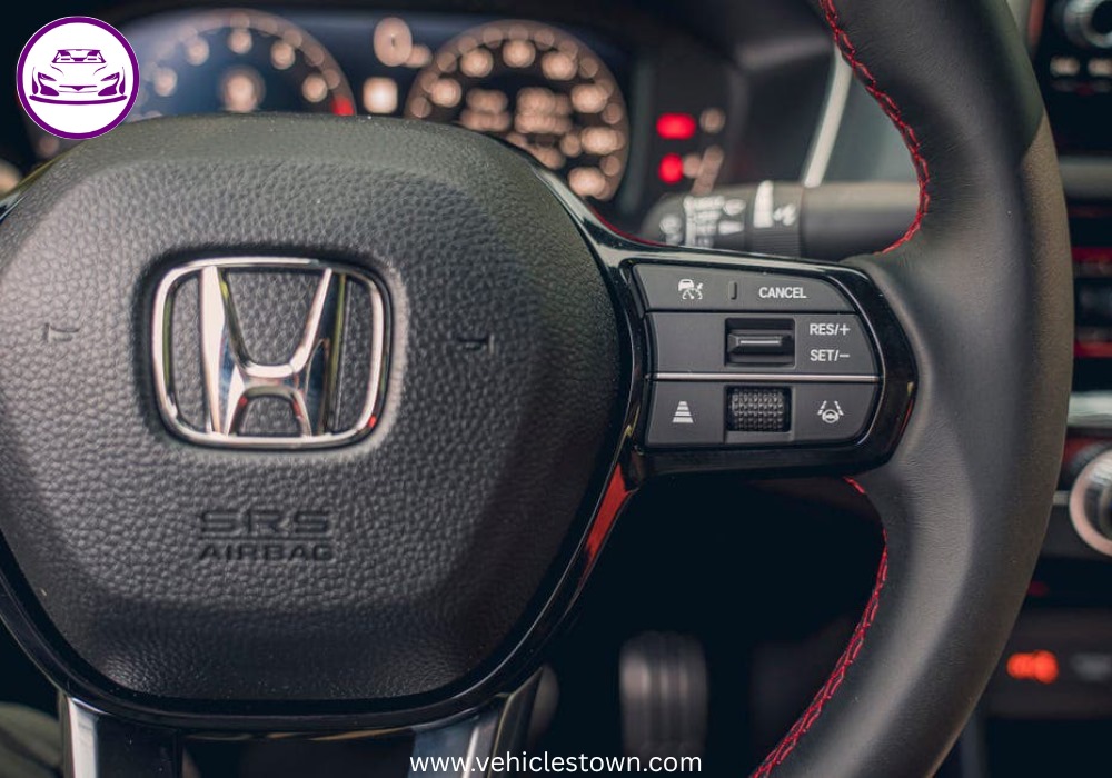 Honda Civic Si sporty red sedan parked, showcasing aggressive front grille and alloy wheels.