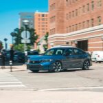 2025 Honda Civic Standard in silver, showcasing sleek design and modern LED headlights.