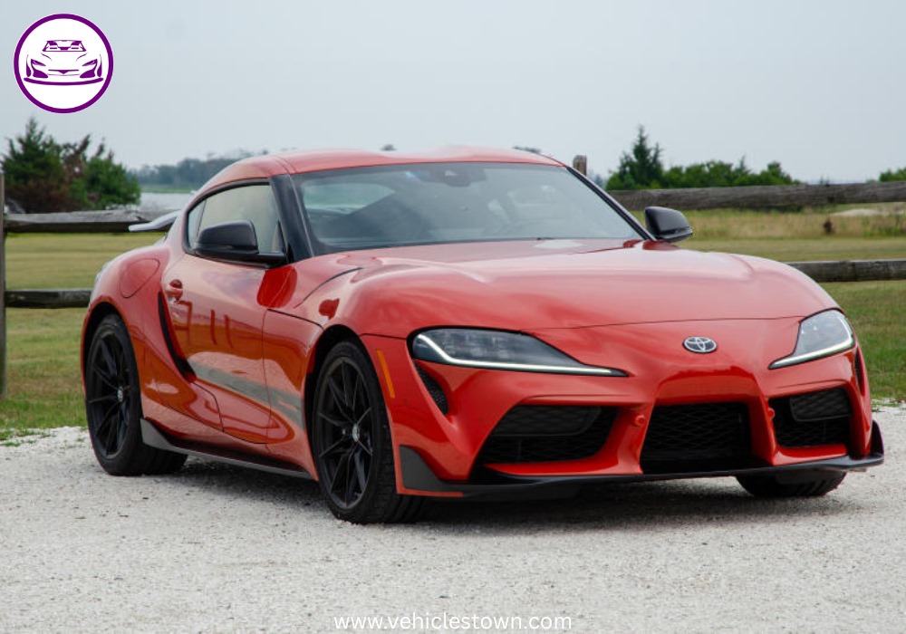 A sleek, red 2025 Toyota GR Supra 3.0 sits parked, highlighting its aggressive styling and ready-to-drive presence.