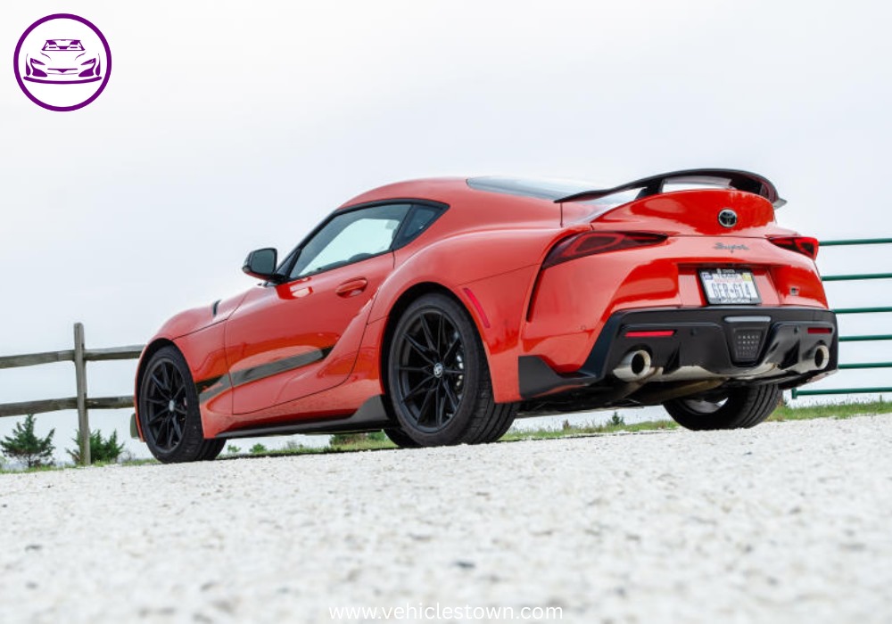 A sleek, red 2025 Toyota GR Supra 3.0 sits parked, highlighting its aggressive styling and ready-to-drive presence.