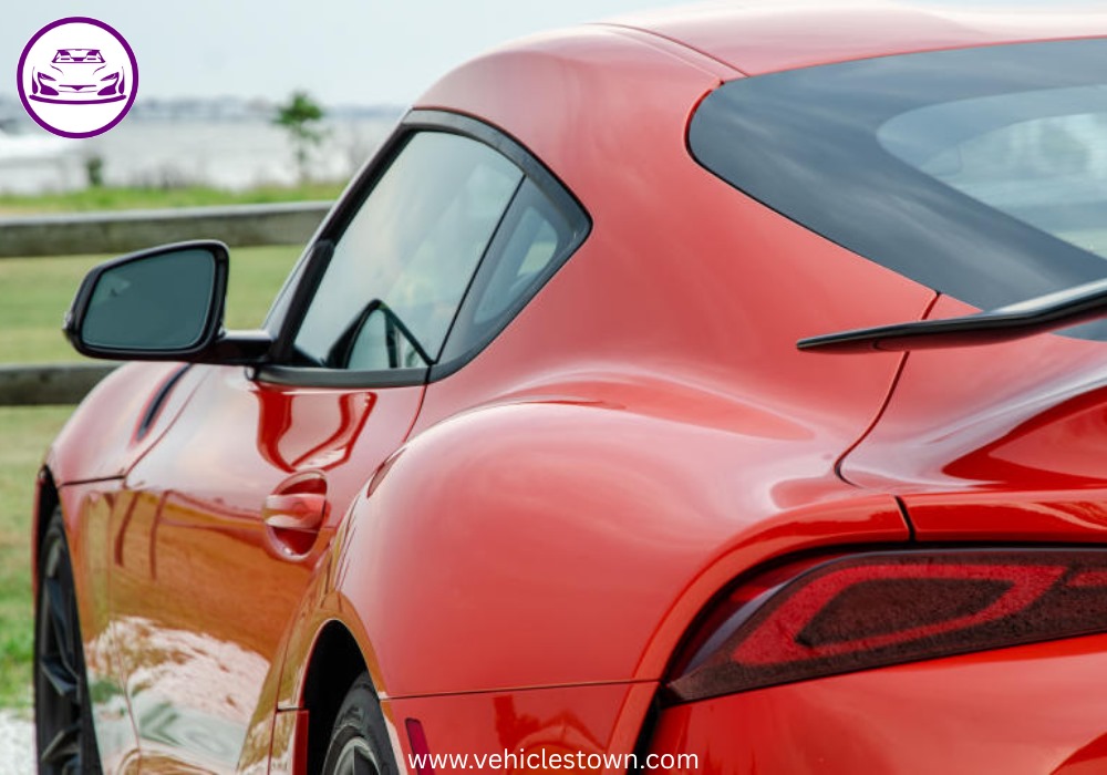 A sleek, red 2025 Toyota GR Supra 3.0 sits parked, highlighting its aggressive styling and ready-to-drive presence.