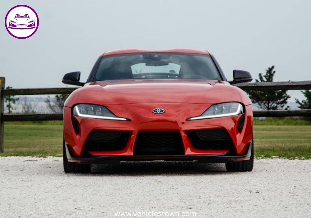 A sleek, red 2025 Toyota GR Supra 3.0 sits parked, highlighting its aggressive styling and ready-to-drive presence.