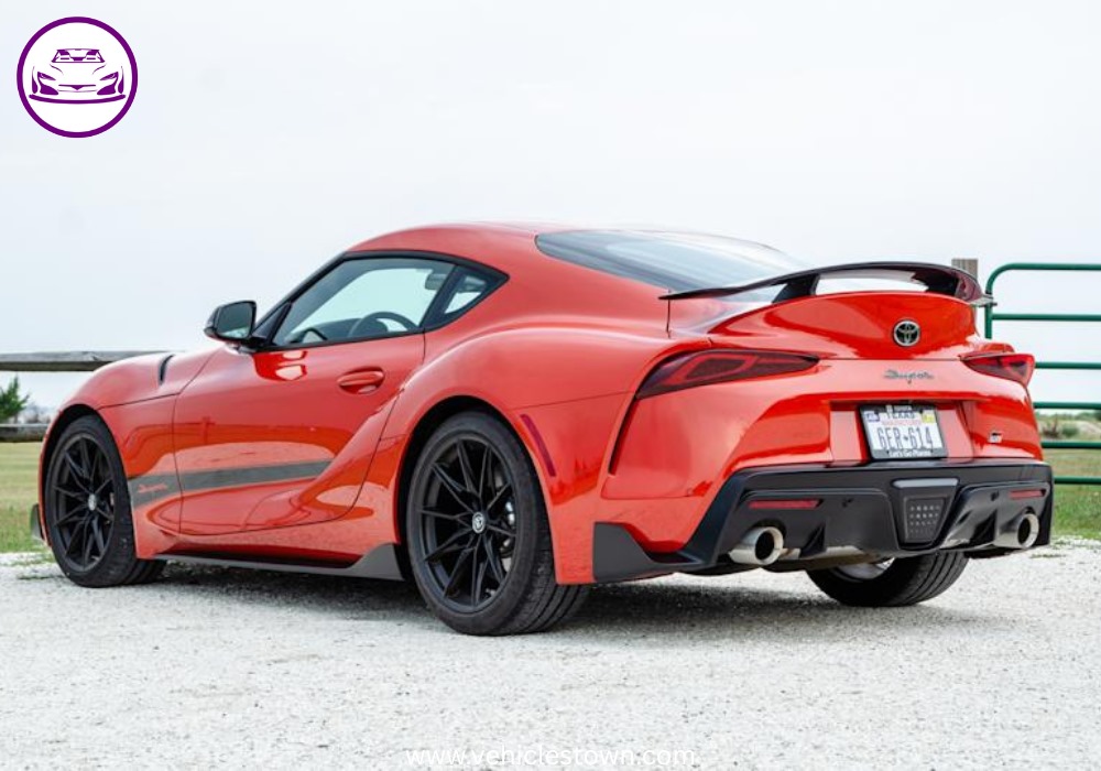 A sleek, red 2025 Toyota GR Supra 3.0 sits parked, highlighting its aggressive styling and ready-to-drive presence.