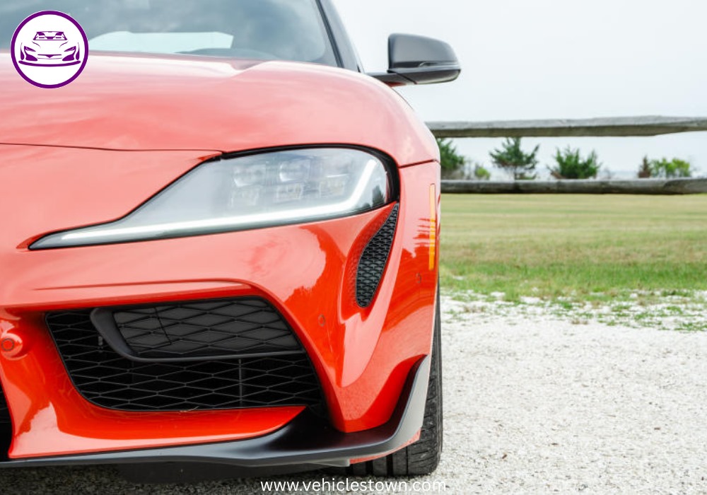 A sleek, red 2025 Toyota GR Supra 3.0 sits parked, highlighting its aggressive styling and ready-to-drive presence.