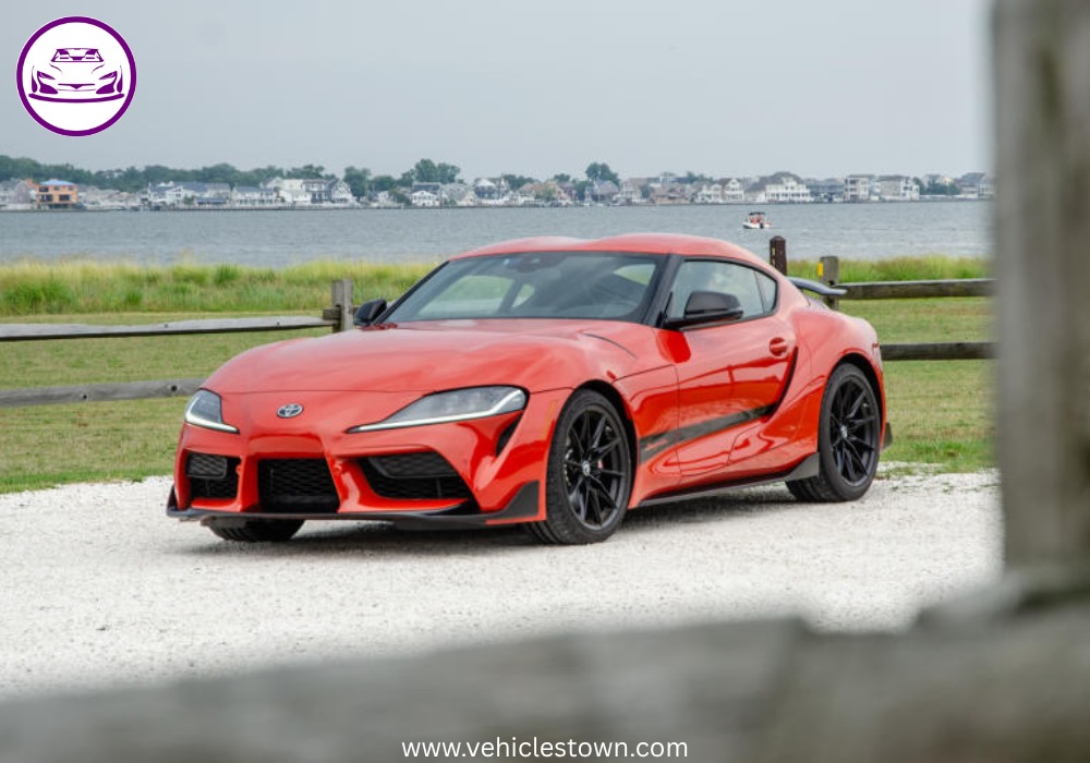A sleek, red 2025 Toyota GR Supra 3.0 sits parked, highlighting its aggressive styling and ready-to-drive presence.