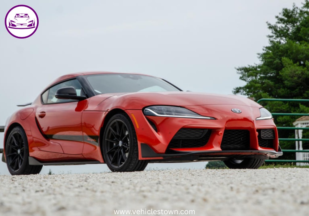 A sleek, red 2025 Toyota GR Supra 3.0 sits parked, highlighting its aggressive styling and ready-to-drive presence.