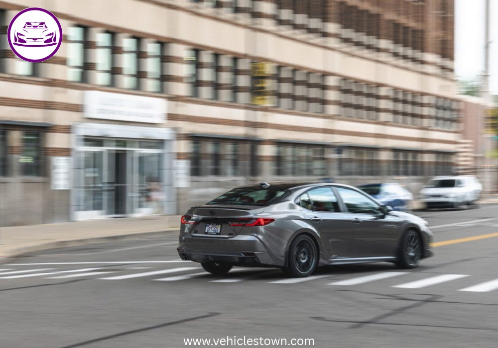 Toyota Camry XSE in a sporty stance featuring blacked-out grille, 19-inch alloy wheels, and aggressive LED headlights on a city street.