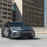 Toyota Camry XSE in a sporty stance featuring blacked-out grille, 19-inch alloy wheels, and aggressive LED headlights on a city street.