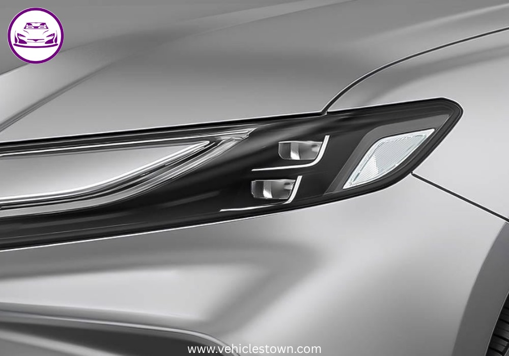 **Alt Text:**
Toyota Camry XLE front and side view showcasing its sleek design, LED headlights, and alloy wheels in a premium urban setting.