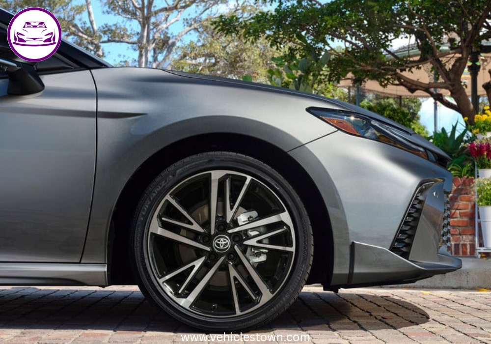 Toyota Camry XSE in a sporty stance featuring blacked-out grille, 19-inch alloy wheels, and aggressive LED headlights on a city street.