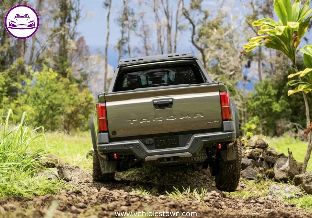 Front angle of the Toyota Tacoma i-FORCE MAX highlighting its bold grille and hybrid badging.