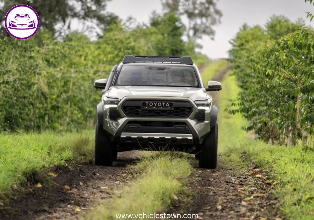 Front angle of the Toyota Tacoma i-FORCE MAX highlighting its bold grille and hybrid badging.