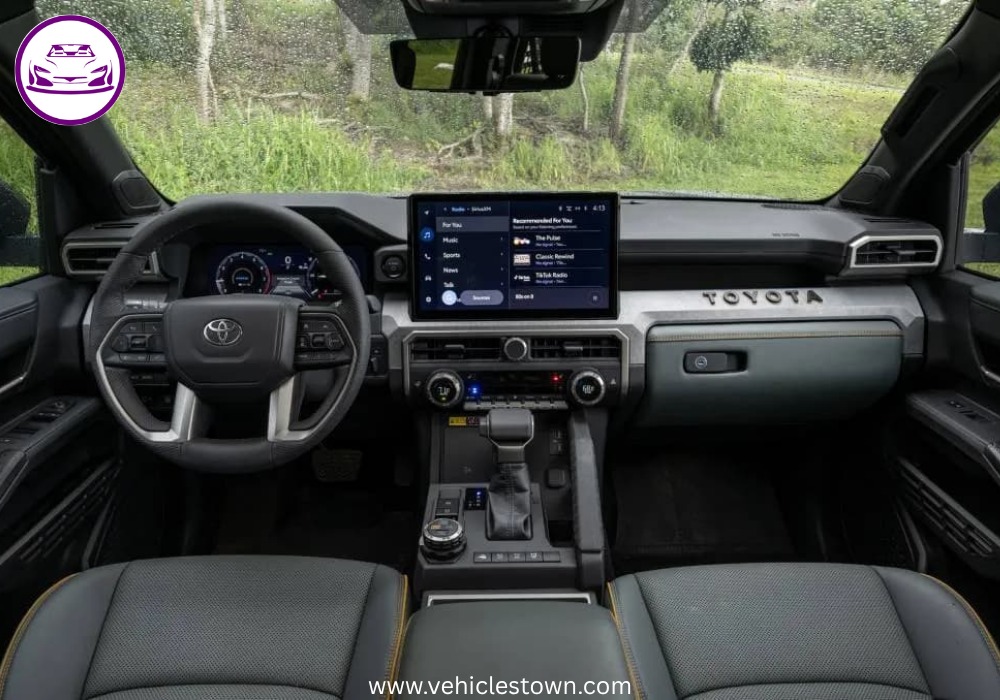Front angle of the Toyota Tacoma i-FORCE MAX highlighting its bold grille and hybrid badging.