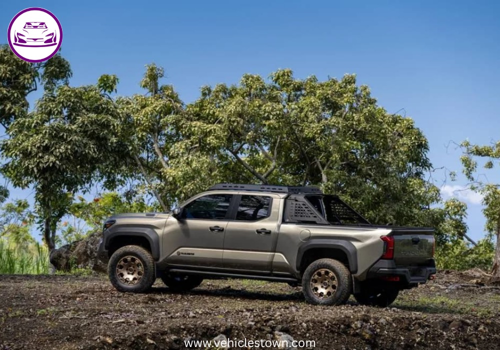 Front angle of the Toyota Tacoma i-FORCE MAX highlighting its bold grille and hybrid badging.