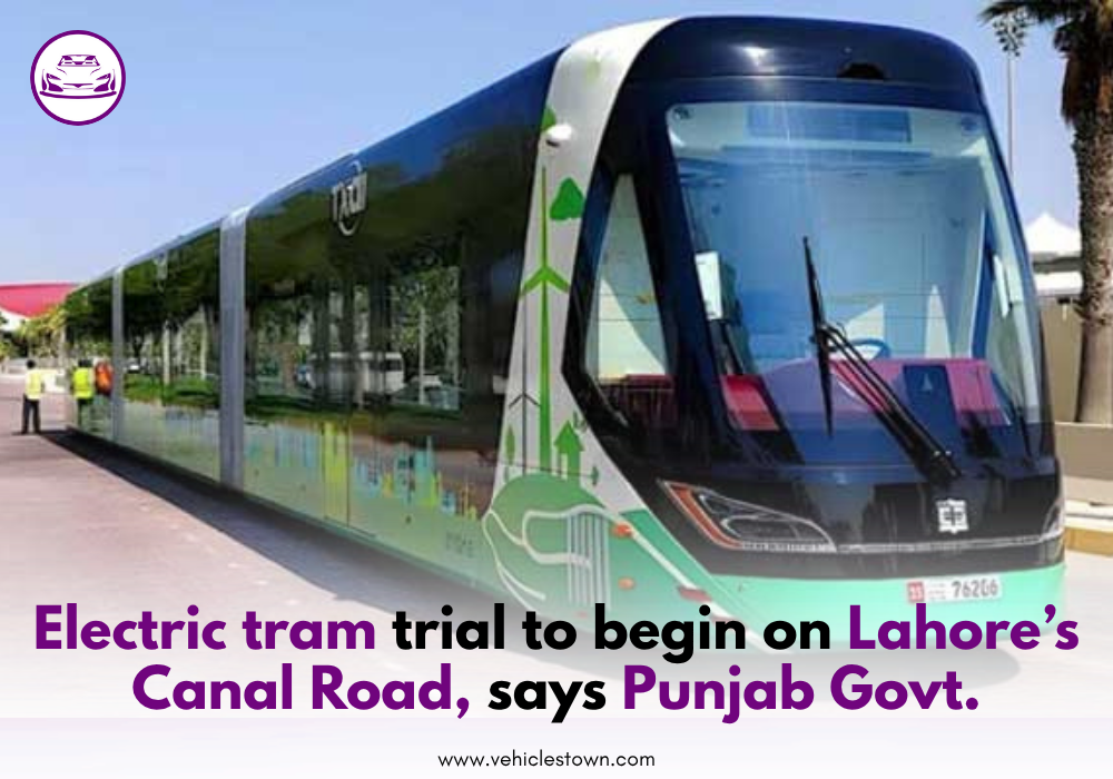 A modern electric tram moving on Lahore's Canal Road during a test run