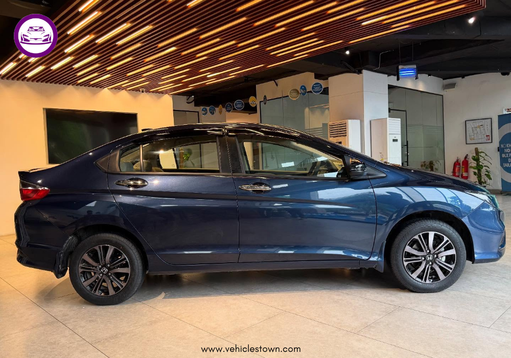 2025 Honda City Aspire S sedan in Canyon River Blue showing sleek LED headlamps and sporty alloy wheels.