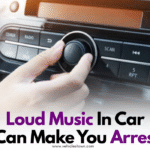 Traffic police stop a car for playing loud music on the road.